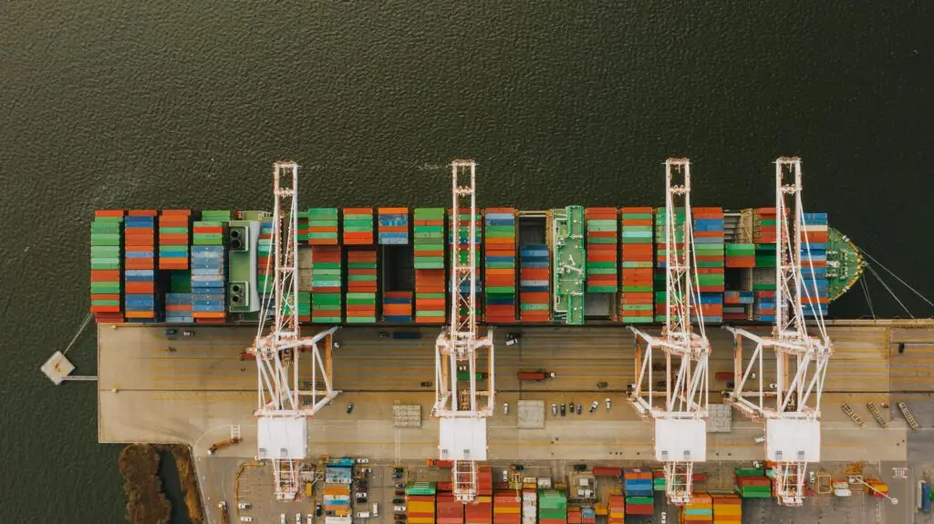 Container port crane system operating on rails secured with industrial crane rail clips